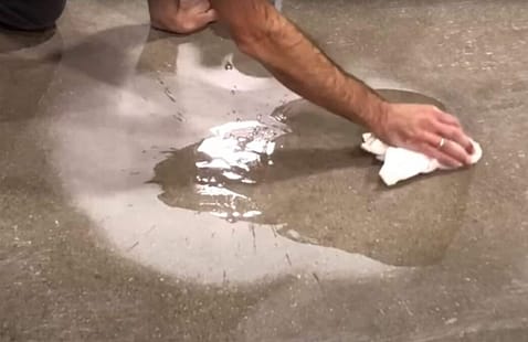 What should I do if a chemical spills on my polished concrete floor?